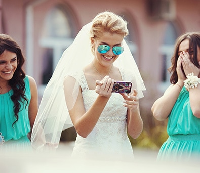Friends share photos at a wedding using Tapestry Show App